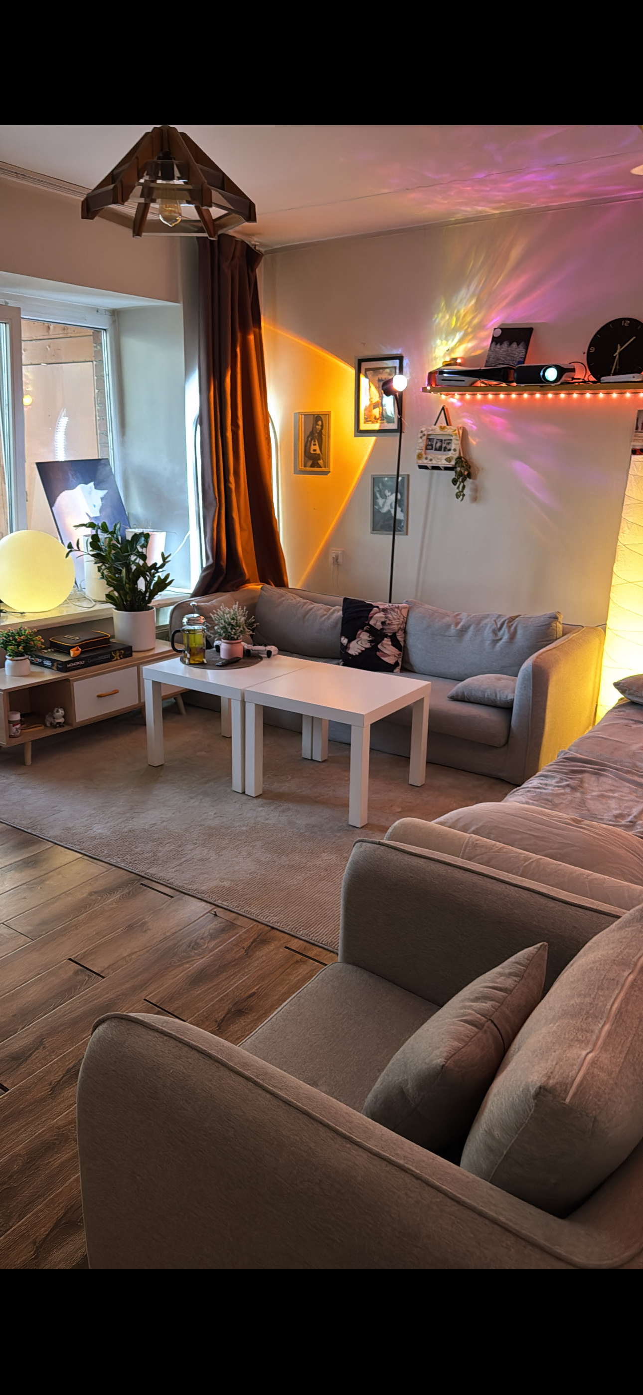 Anar's living room in Ulaanbaatar, warm lamps, plants, projector